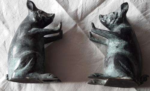 set of stone bookends with pigs