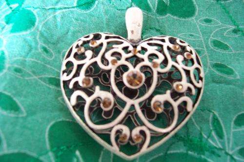 Tibetian silver heart shaped pendant with brown inlays