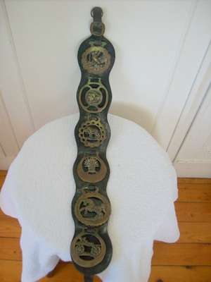 HORSE BRASS x 6.  ON LEATHER STRAP