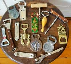 A COLLECTION OF BOTTLE OPENERS.
