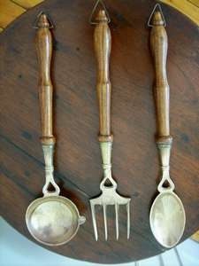 A SET OF BRASS KITCHEN UTENSILS