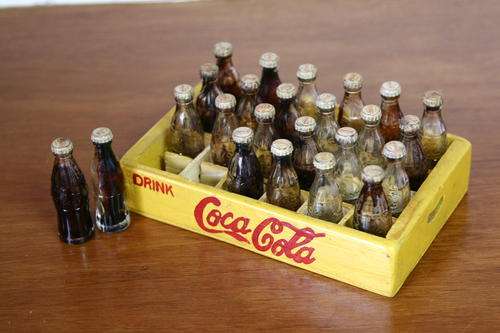 Coca-Cola, 24 miniture glass bottles in wooden tray