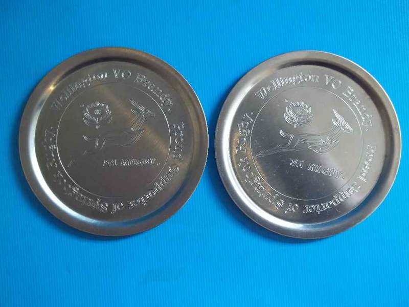 2 X Metal Coasters: "Wellington VO Brandy, Proud Supporters Of Springbok Rugby" Diameter 9cm