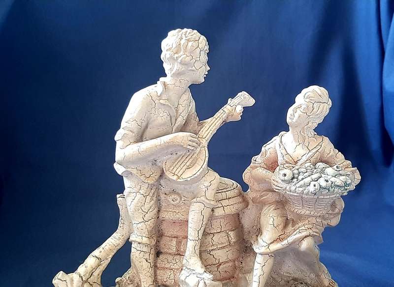 VINTAGE STATUE OF MAN SERENADING A WOMAN