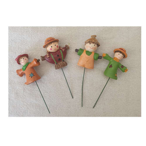 A set of four scarecrow flower arrangements