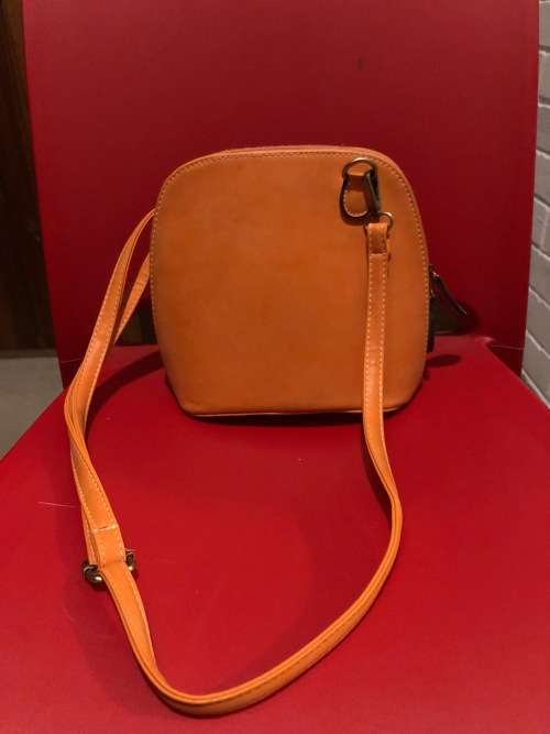 Lovely orange leather sling handbag