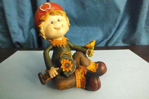 Boy sitting with flowers and spade