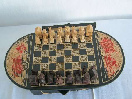 CHESS BOARD AND CARVED PIECES