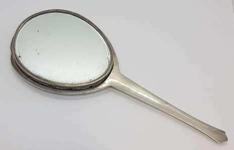 Silver hand held mirror - as per scan