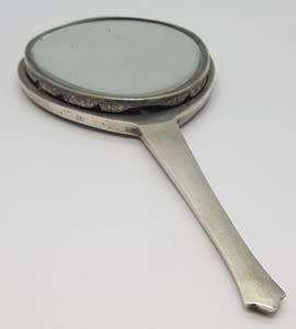 Silver hand held mirror - as per scan