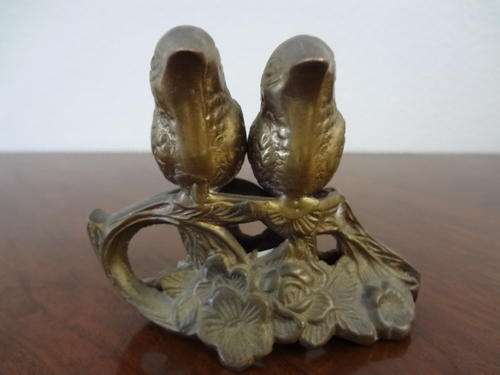 Pair of brass sparrows sitting very still as per photo