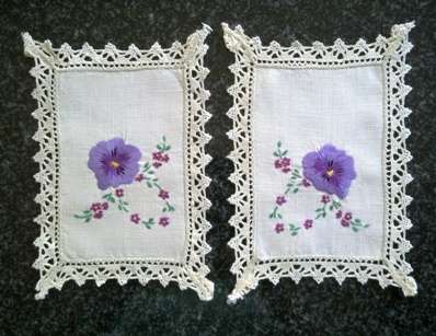 Two hand embroidered linen doilies