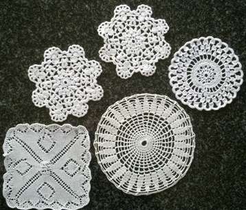Five white mini doilies