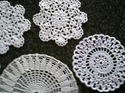Five white mini doilies