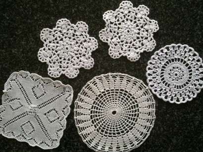 Five white mini doilies
