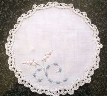 Dainty hand embroidered linen doilie 21cm