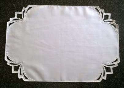 Four white cotton placemats