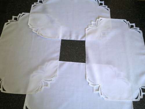 Four white cotton placemats