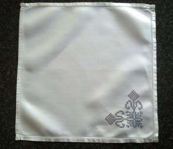 Ten hand embroidered white linen dinner serviettes