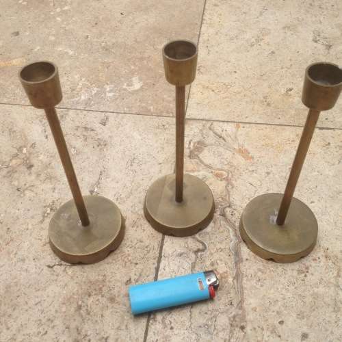 three brass candle stick holders , made in india