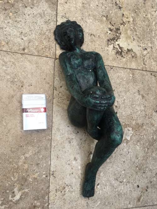 bronze sculpture figure of nude woman laying on back