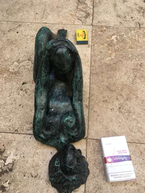 bronze sculpture figure of nude woman laying on back