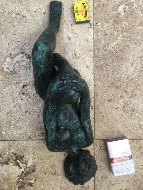 bronze sculpture figure of nude woman laying on back