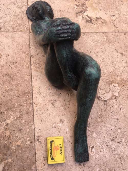 bronze sculpture figure of nude woman laying on back