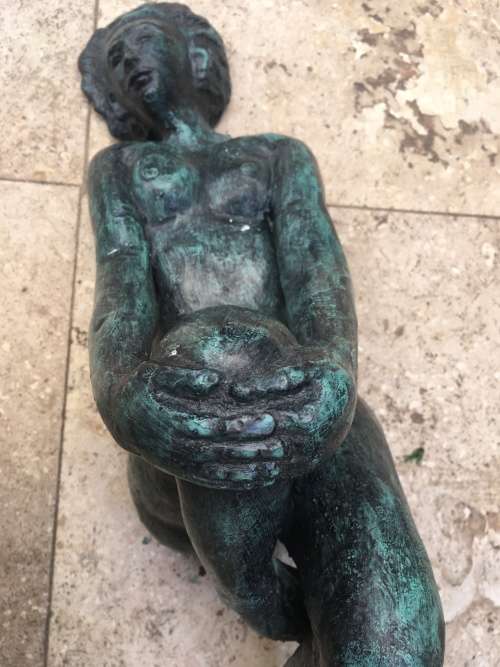 bronze sculpture figure of nude woman laying on back