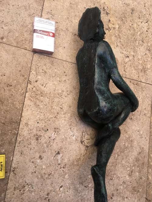 bronze sculpture figure of nude woman laying on back