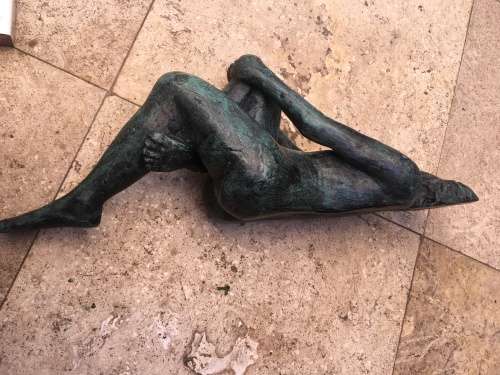 bronze sculpture figure of nude woman laying on back