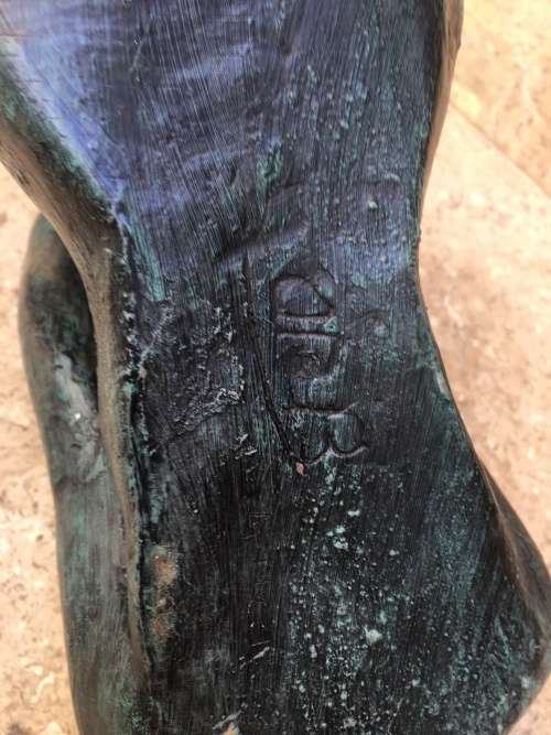 bronze sculpture figure of nude woman laying on back