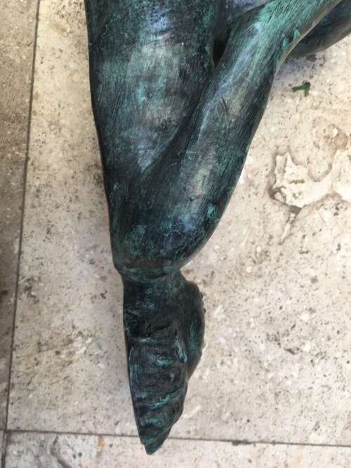 bronze sculpture figure of nude woman laying on back