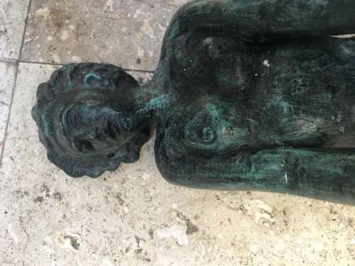 bronze sculpture figure of nude woman laying on back