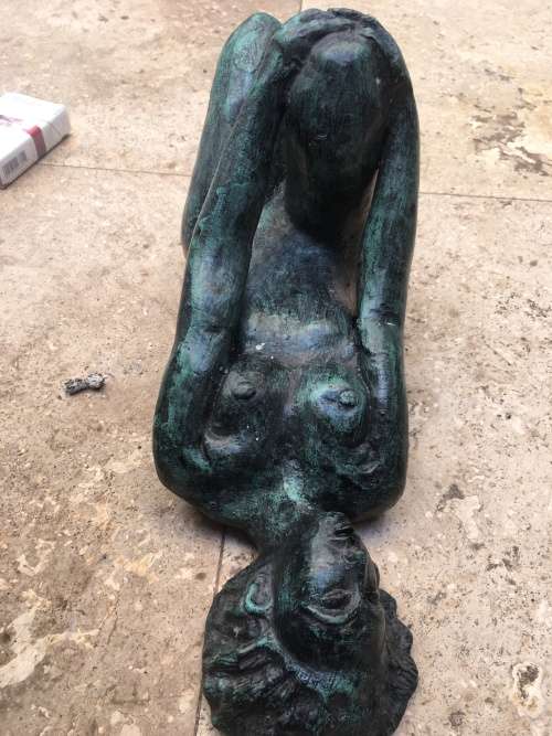 bronze sculpture figure of nude woman laying on back
