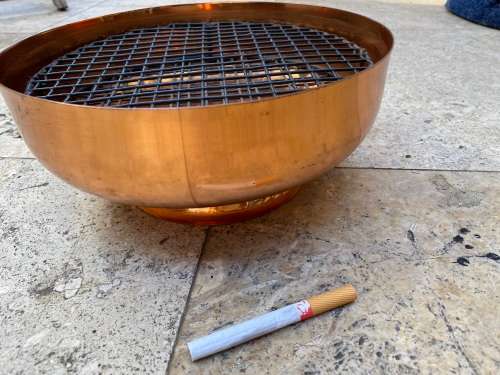 copper round footed vase with frog grate