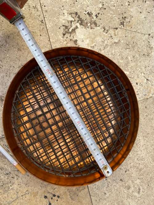 copper round footed vase with frog grate