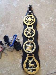 4 horse brasses on black leather strap