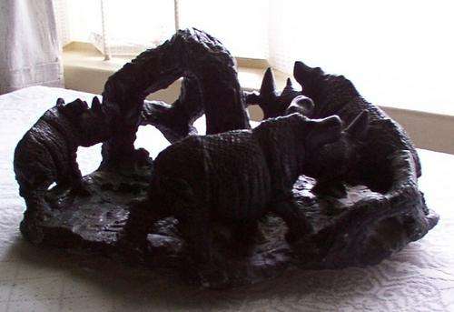 Three rhinoceros (rhino) with tree, table centre, blacked stone