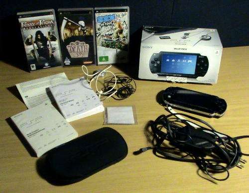 PSP -1004 K Sony console and value pack with 3 games.
