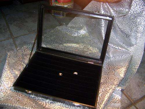 Black velvet ring boxes with glass lid.