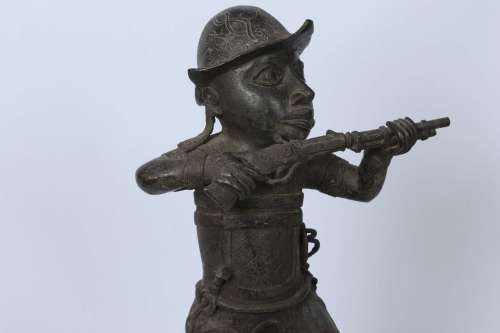 Brass figure of a Portuguese soldier holding a musket - Benin Nigeria