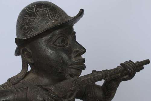 Brass figure of a Portuguese soldier holding a musket - Benin Nigeria