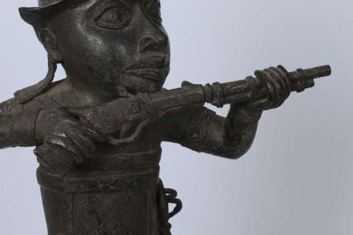 Brass figure of a Portuguese soldier holding a musket - Benin Nigeria