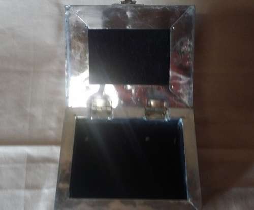 A METAL TRINKET BOX  BLACK MATERIAL  LINED