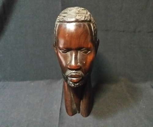 A SOLID WOODEN CARVED SCULPTURE