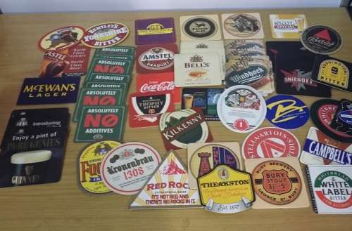 A COLLECTION OF ASSORTED BEER MATS COASTERS