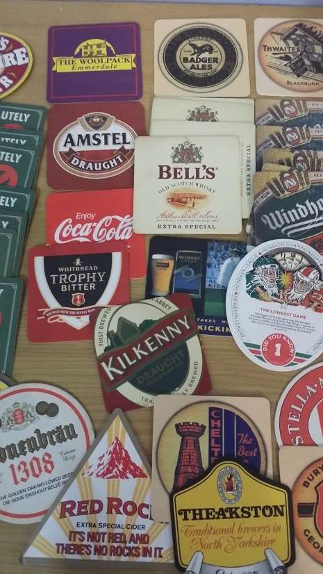 A COLLECTION OF ASSORTED BEER MATS COASTERS
