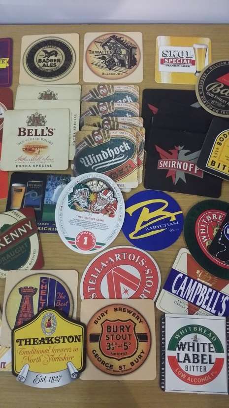 A COLLECTION OF ASSORTED BEER MATS COASTERS