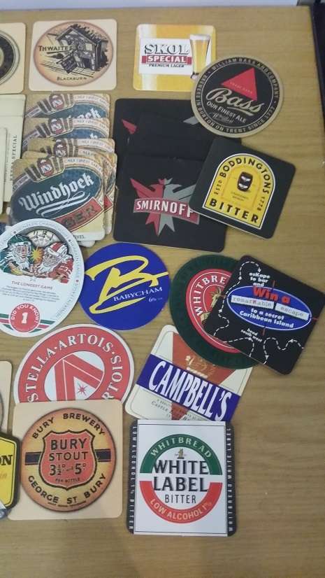 A COLLECTION OF ASSORTED BEER MATS COASTERS